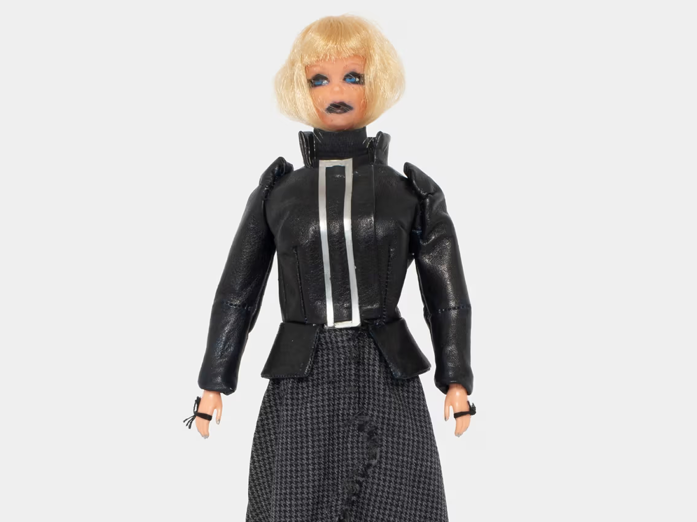 Fashion doll wearing a dark archival look